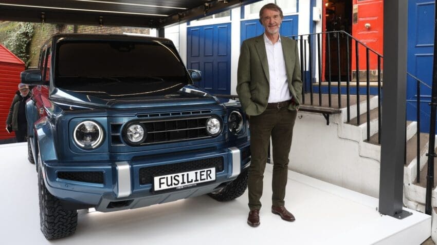 Sir Jim Ratcliffe postpones Ineos' electric vehicle project due to low demand and unclear net zero policies.